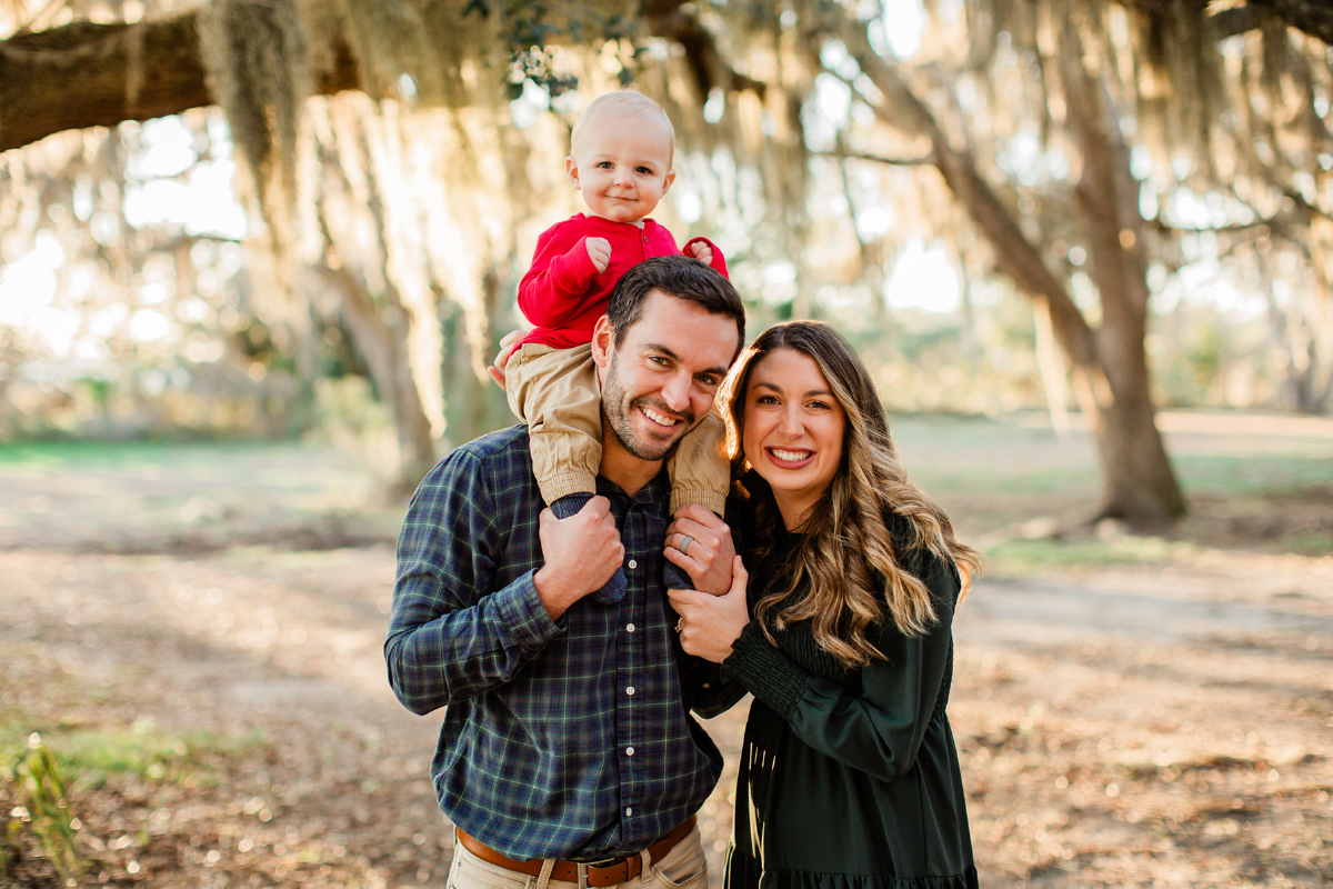 parents with baby posing for photo session in charleston