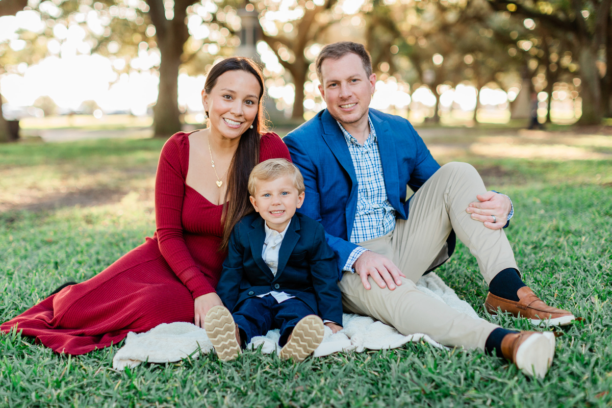 parents with child sitting for photo session in charleston